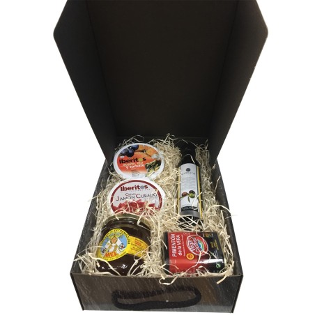 Cesta pequeña con pimentón, aceite, miel, jamón curado y lata aceite, ajo y tomate para empresas