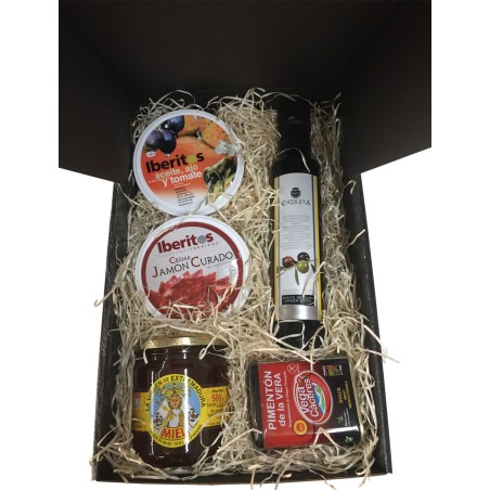 Cesta pequeña con pimentón, aceite, miel, jamón curado y lata aceite, ajo y tomate para empresas